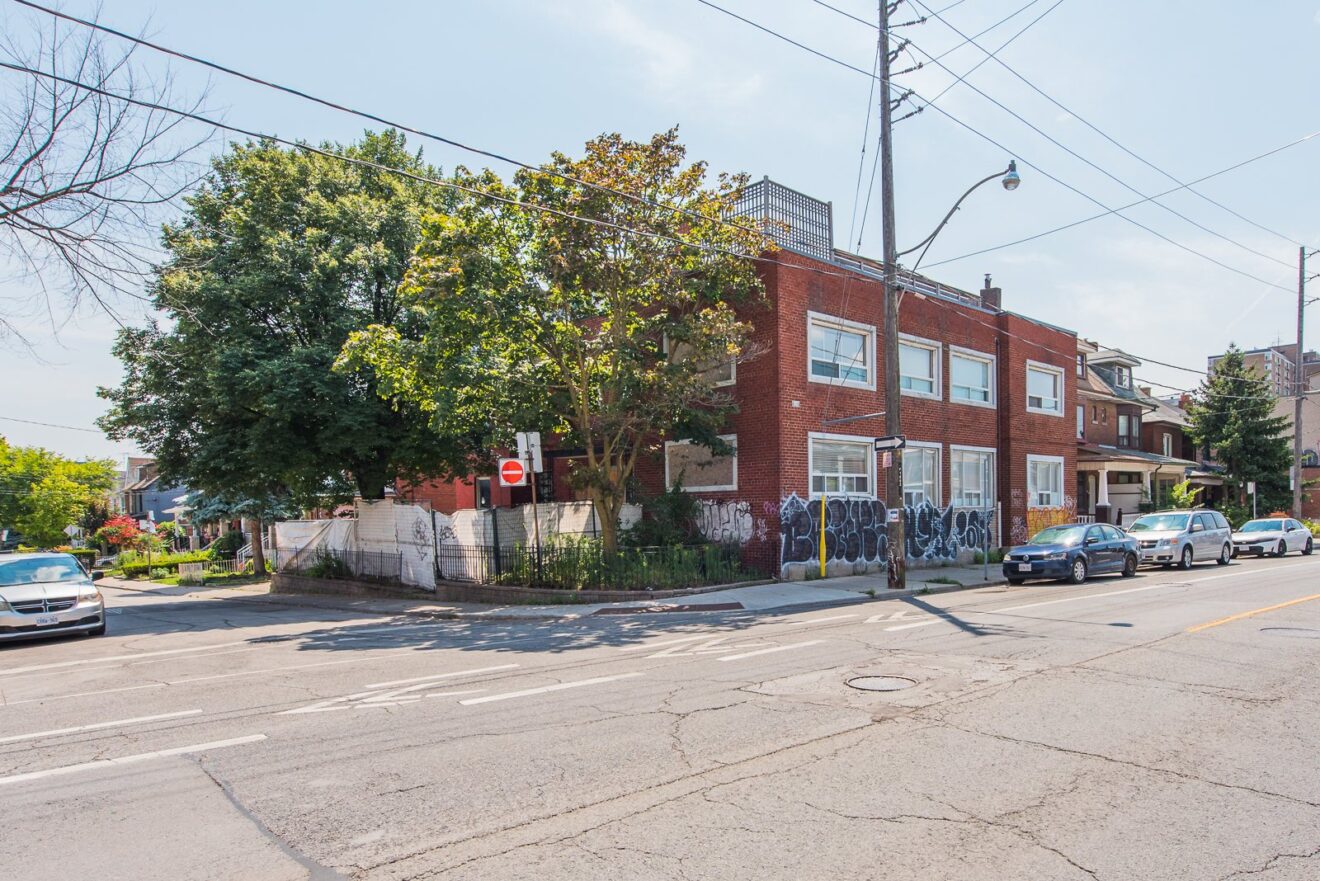 Two and a half storey brick corner building at Davenport Road and Perth Avenue, Toronto