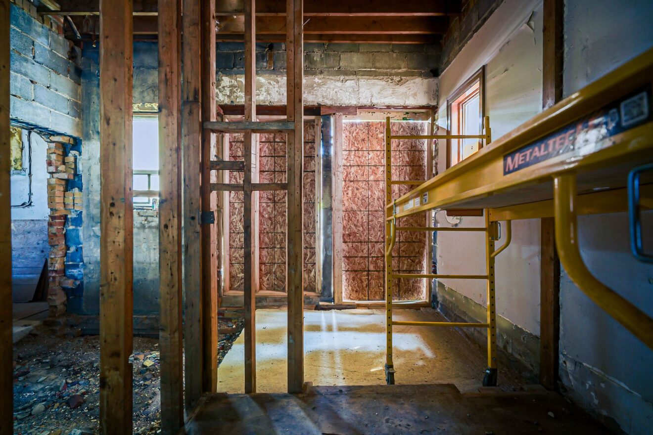 Walkout lower level with high ceilings and scaffolding in place