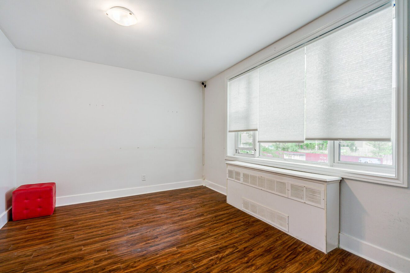 Bright front room with a large window in the second-floor space at 3223 Yonge St