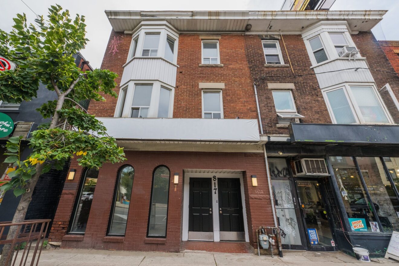 817 Bloor St W exterior, three-storey brick building with arched storefront windows