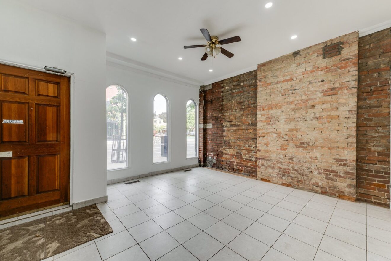 Grade-level commercial unit with exposed brick wall